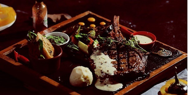 Beautifully presented tomahawk steak on the table.